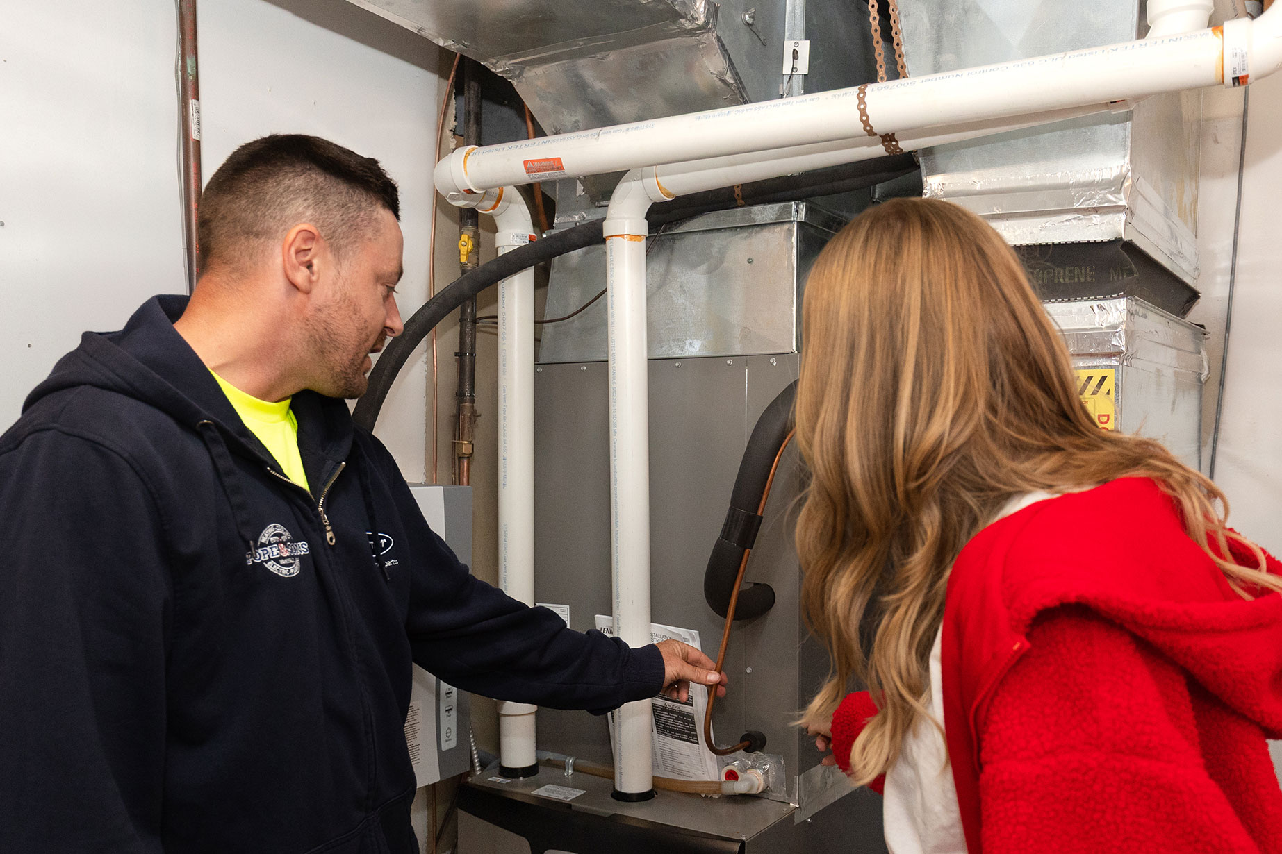 technician explaining furnace services to homeowner