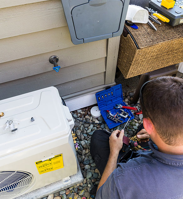 Pope & Sons technician installing a heat pump